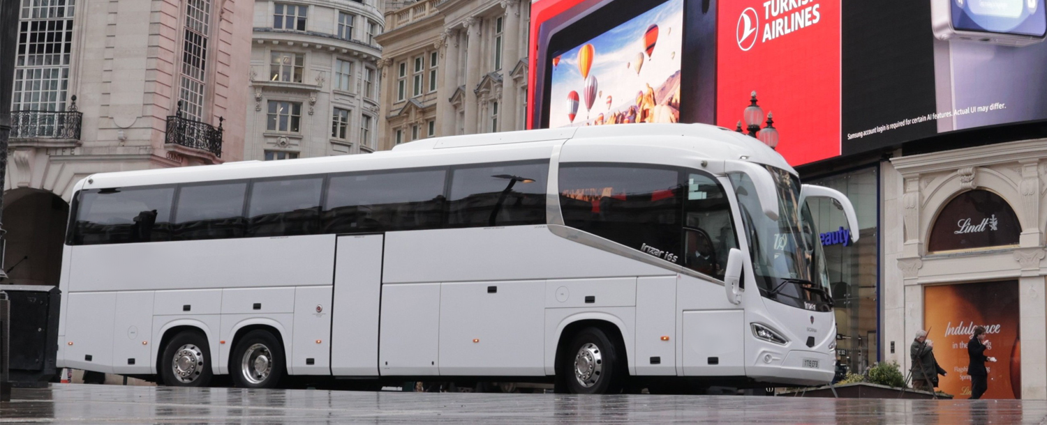 Group travellers boarding a coach for London group transfers.